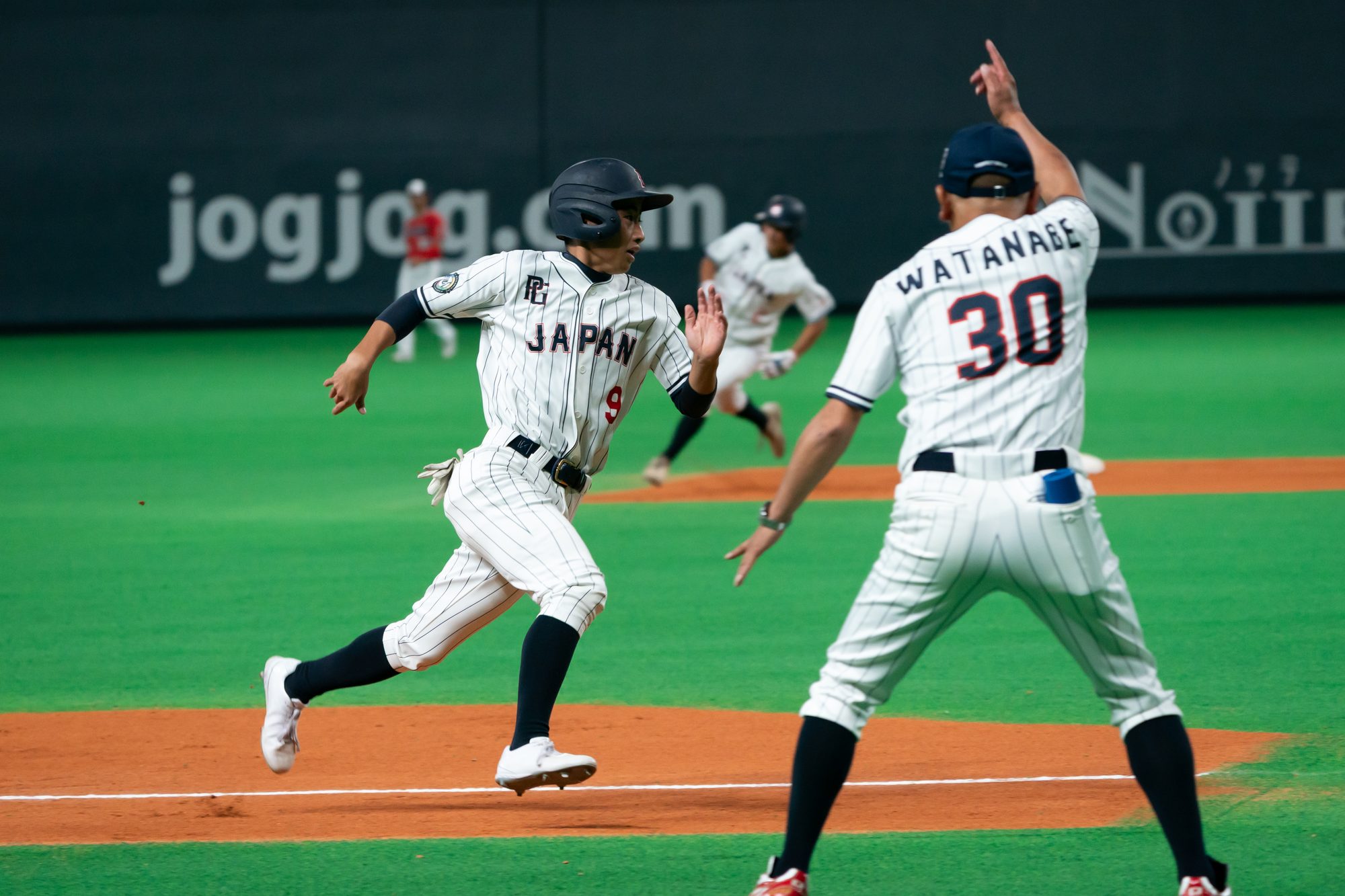 A Japanese student-athlete sprinting during international competition
